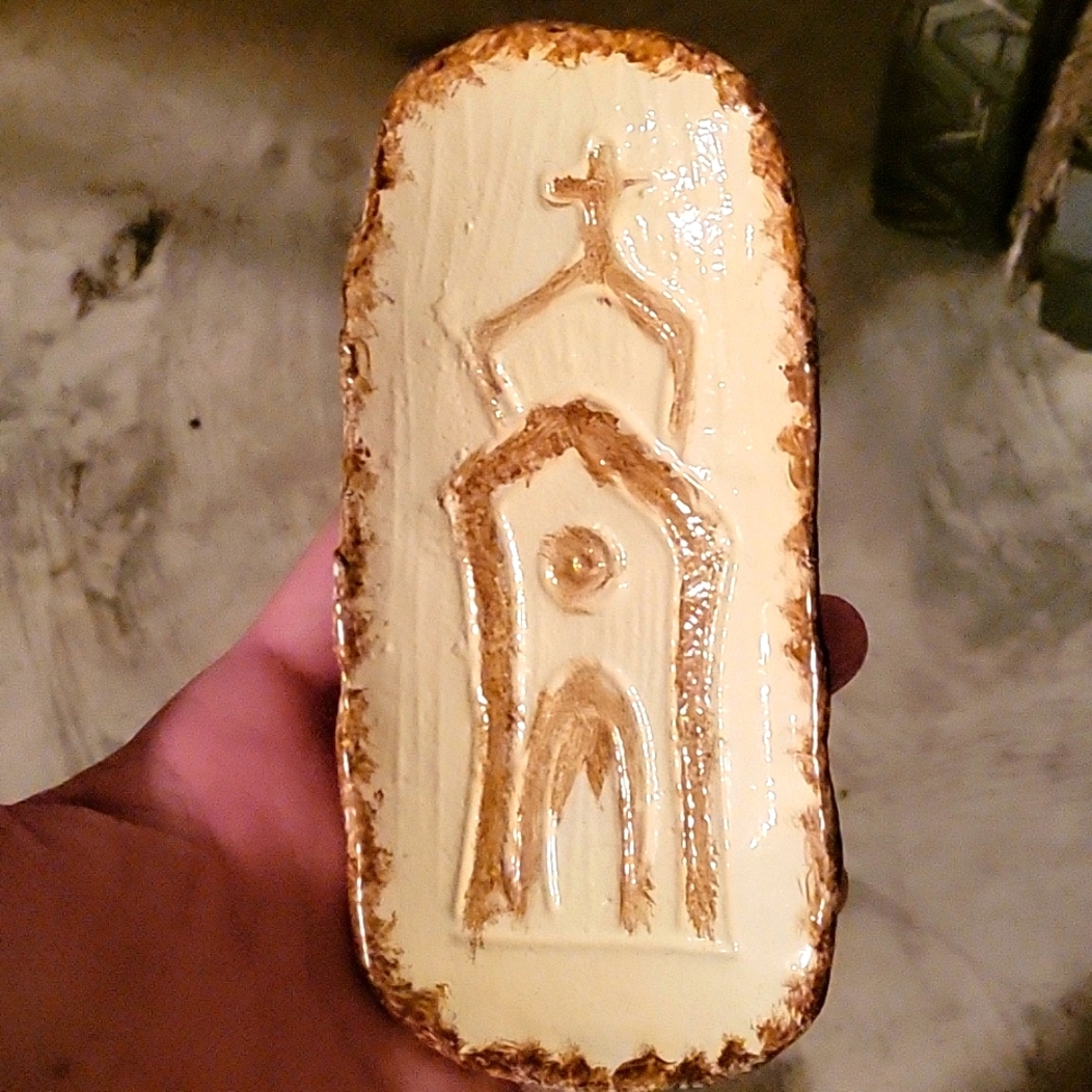Decorative embossed cast iron dish with church